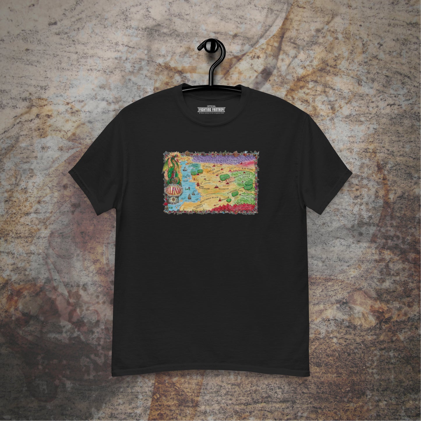Allansia map design on a black t-shirt hanging in front of a stone wall background.