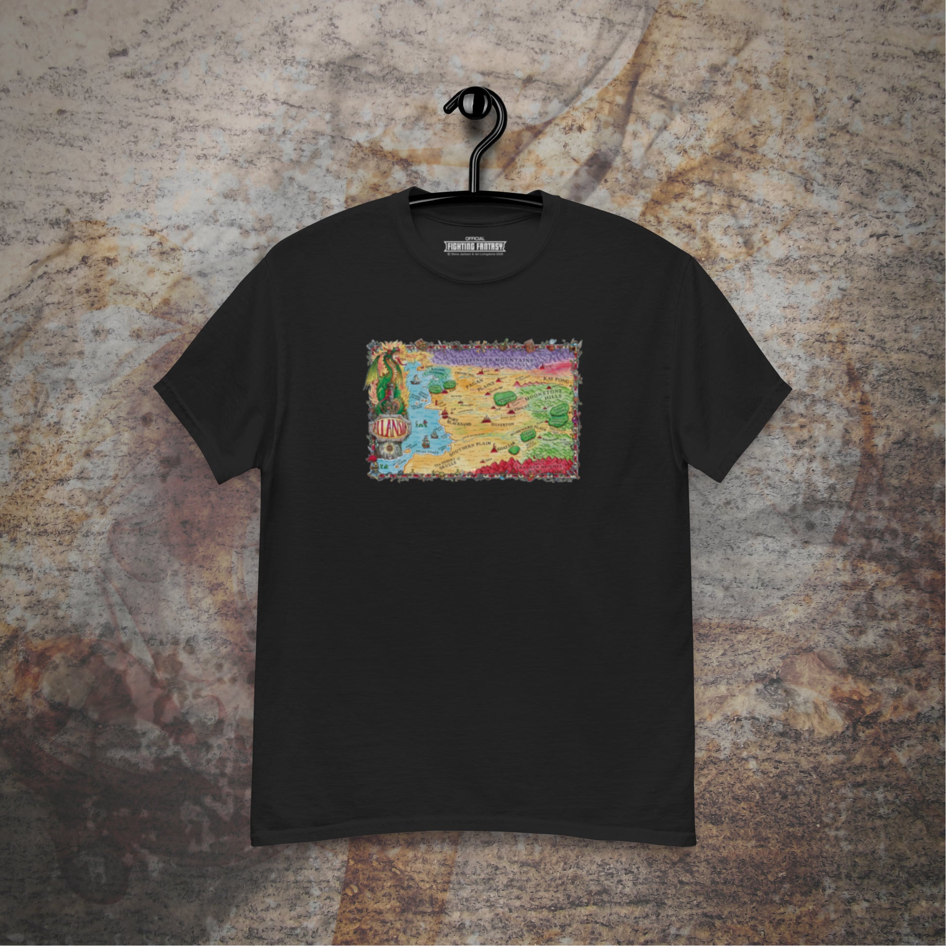Allansia map design on a black t-shirt hanging in front of a stone wall background.
