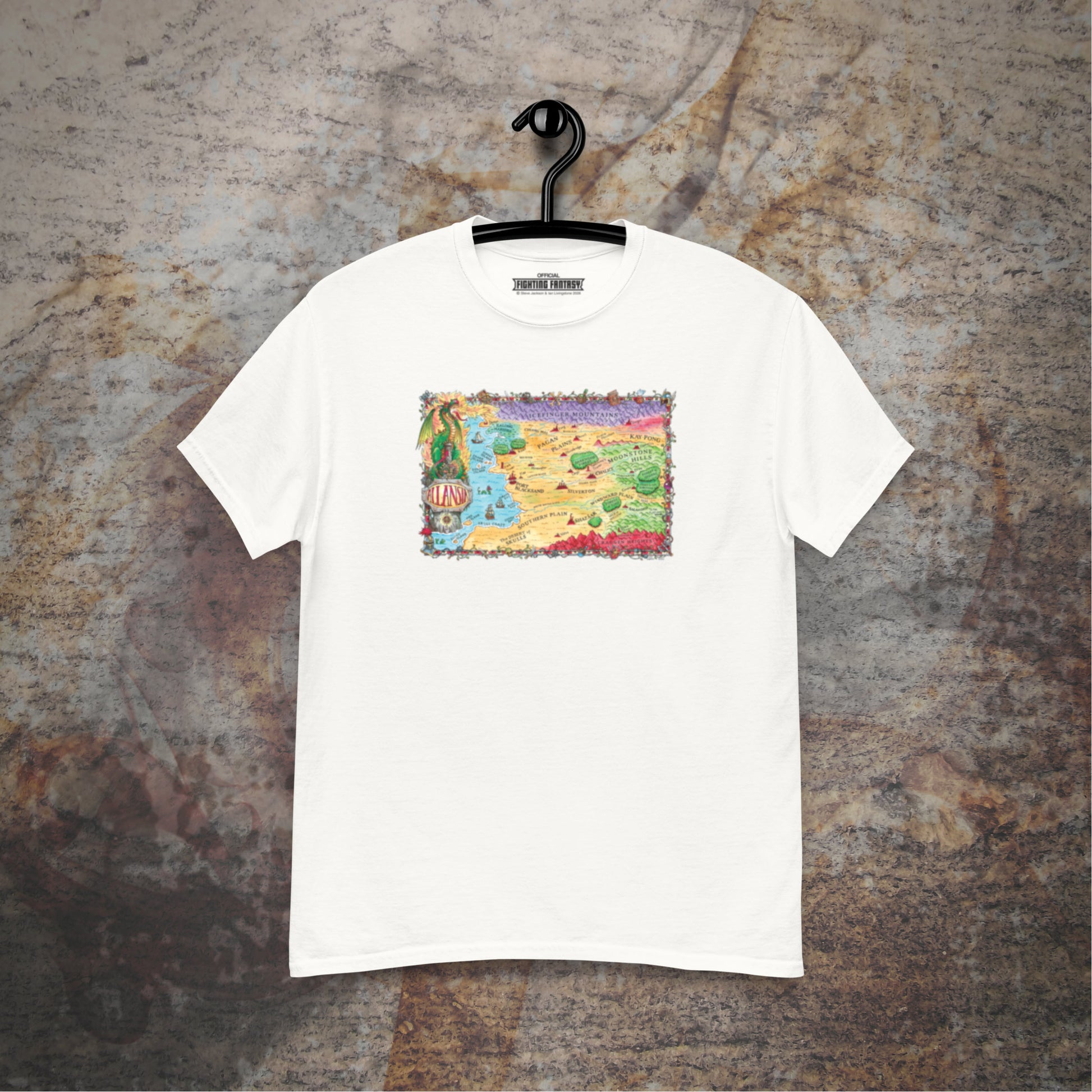 Allansia map design on a white t-shirt hanging in front of a stone wall background.