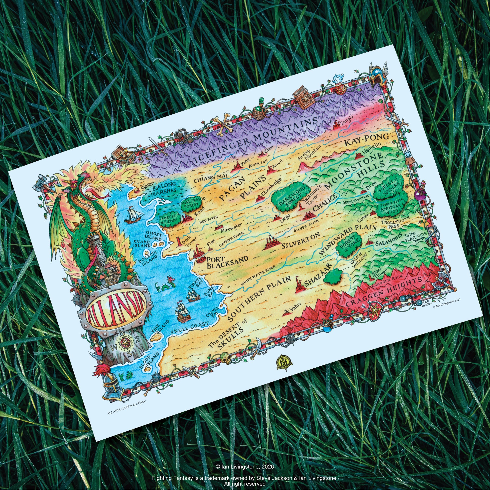 Official art print of NW Allansia: A beautifully detailed fantasy map of the 'Land of Adventure' illustrated by Leo Hartas. Art print shown lying on long green grass.