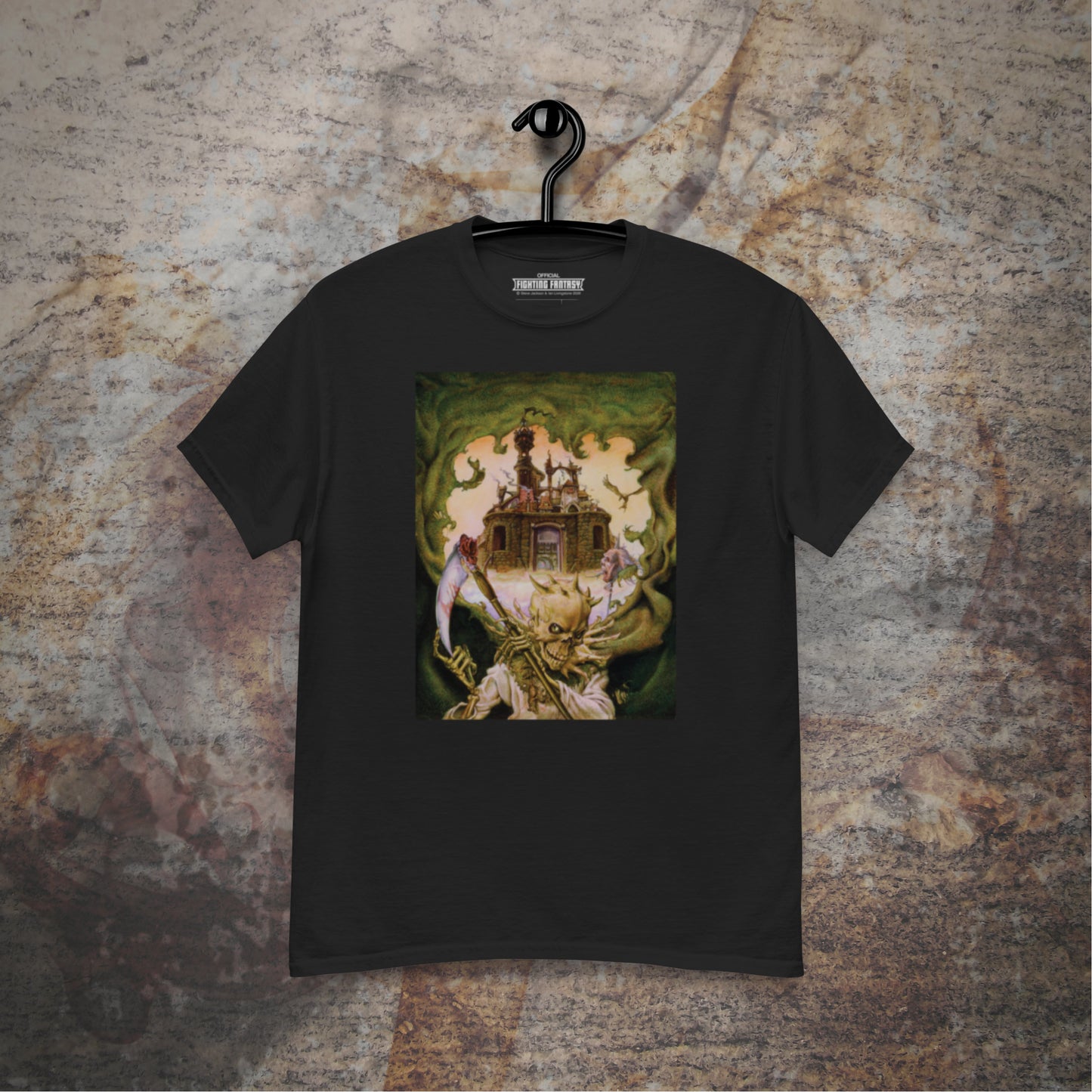 City of Thieves design on a black t-shirt hanging in front of a stone wall background.