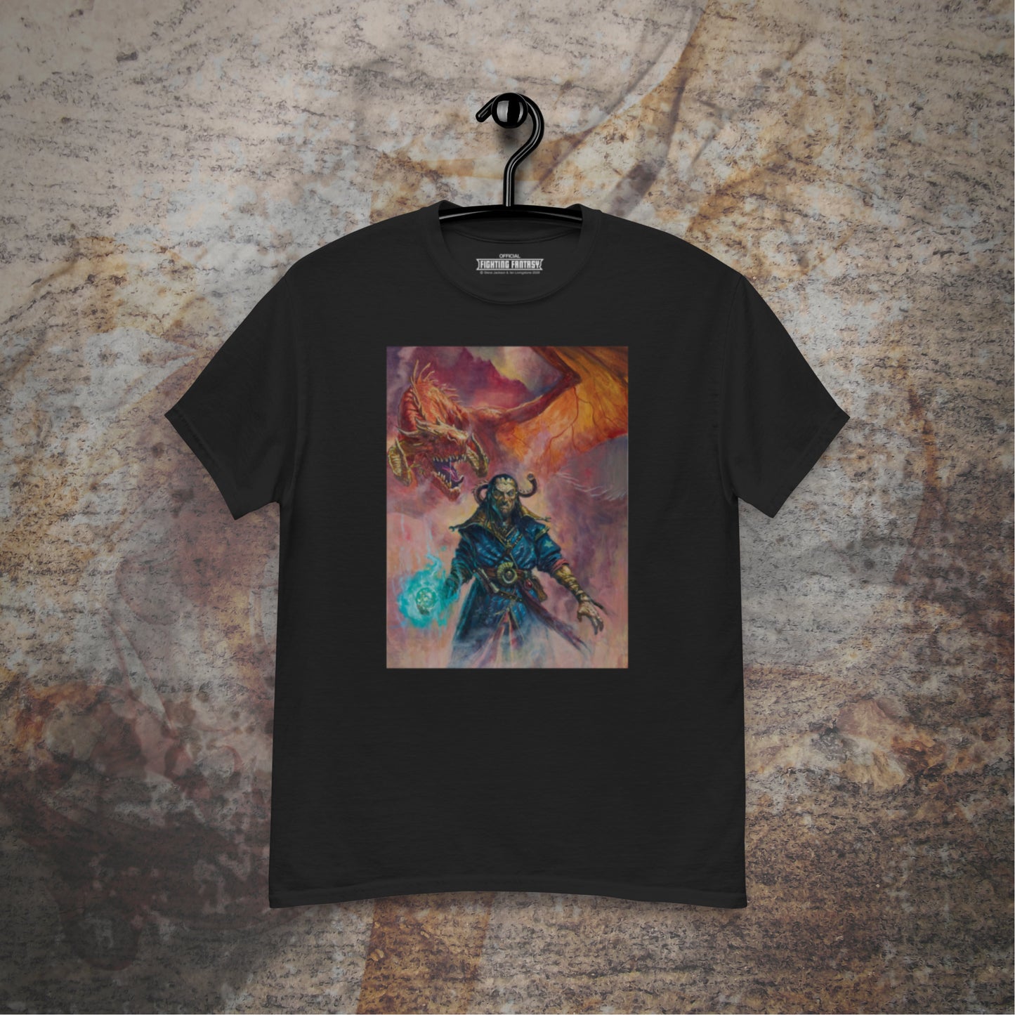 Warlock of Firetop Mountain design on a black t-shirt hanging in front of a stone wall background.