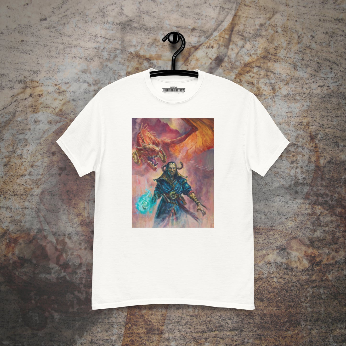 Warlock of Firetop Mountain design on a white t-shirt hanging in front of a stone wall background.